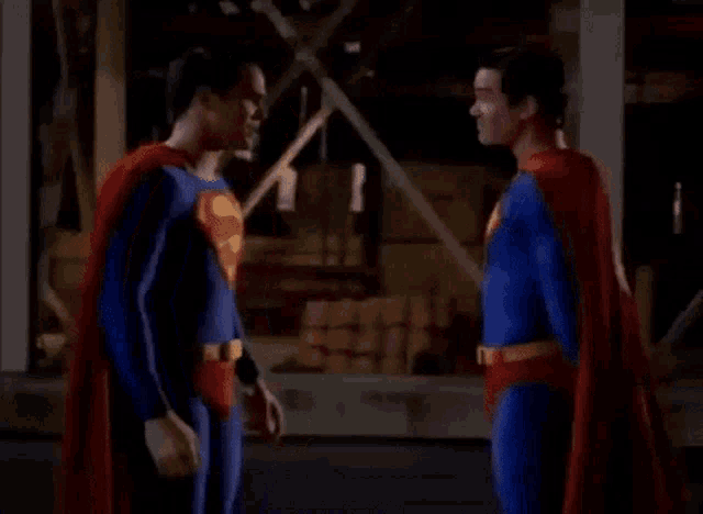 two superheroes are standing next to each other in a building