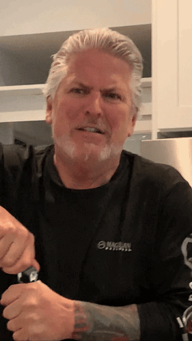 a man is wearing a black shirt with the word michael on it