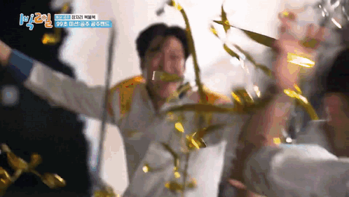 a man with his arms outstretched is surrounded by confetti and a sign that says k2 on it