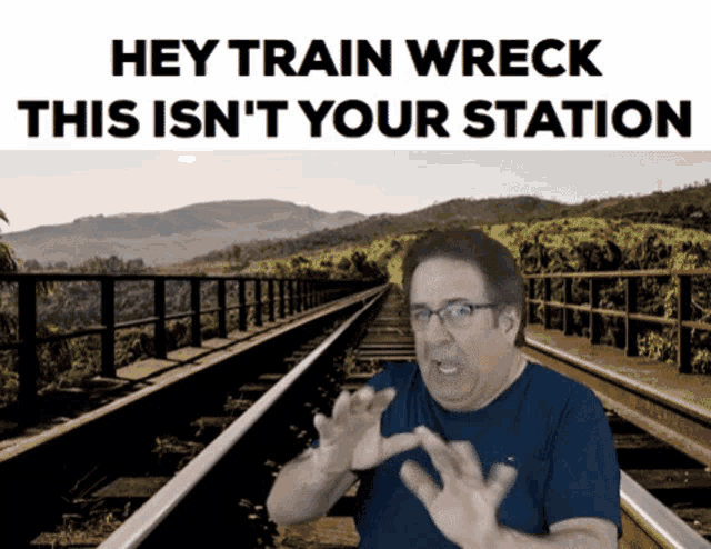 a man standing on train tracks with the words hey train wreck this is n't your station