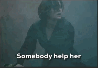 a woman in a dark room with the words " somebody help her " on the bottom