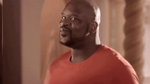 Shaq turns with a pleased, excited expression.