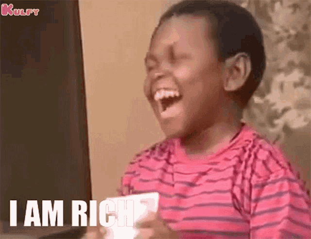 a young boy is laughing with the words " i am rich " above him