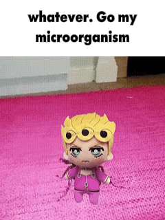 Giorno figure stands on pink carpet under “whatever. Go my microorganism.”