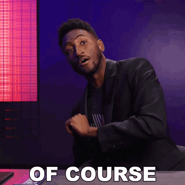 a man in a suit is sitting at a table with the words of course written on it