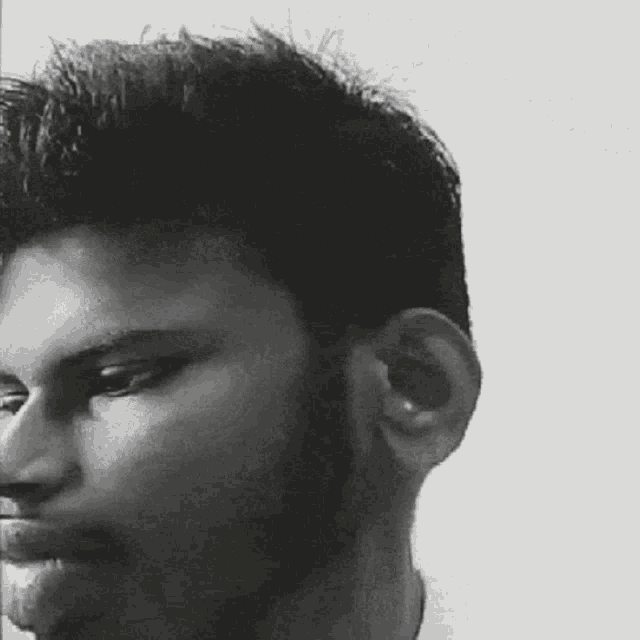 a black and white photo of a man 's face
