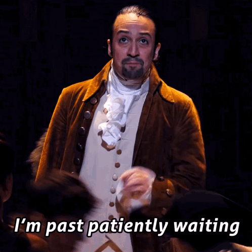 a man in a brown jacket and white vest says " i 'm past patiently waiting "