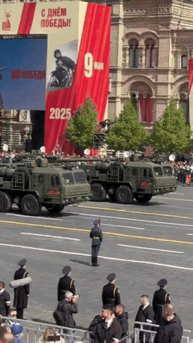 a military parade with a banner that says 9 man on it