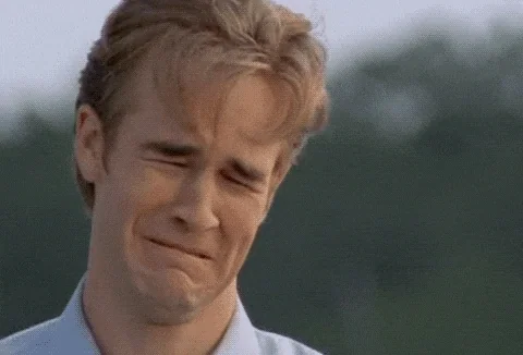 A man cries with his eyes shut in a close-up shot.