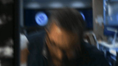 a blurry picture of a person 's face with a blue circle in the background that says nb