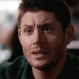 Dean Winchester looks puzzled and concerned in a close-up.