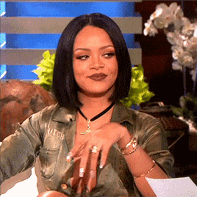 Rihanna gestures with a skeptical side-eye look.