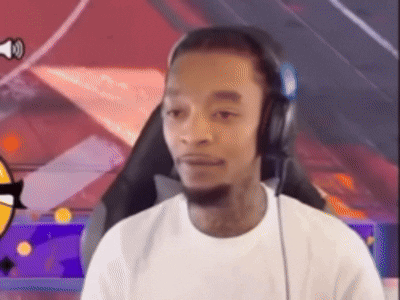 A man wearing headphones stares sideways with a tense, uncertain expression.