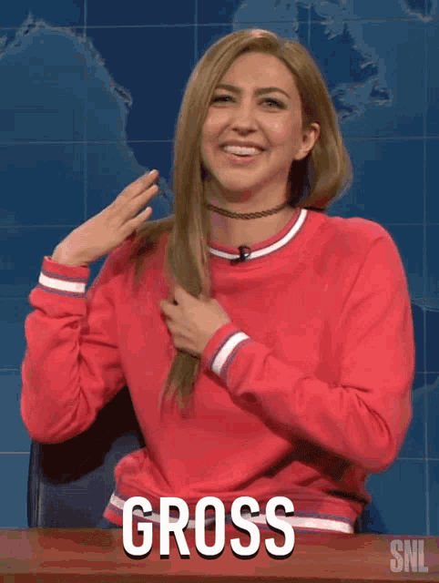 A woman in a red top laughs and says “GROSS” on Saturday Night Live.