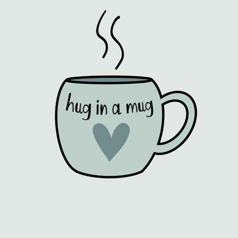 A steaming mug says “Hug in a mug” with a heart design.