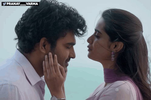 A couple gaze closely at one another in a romantic film scene.