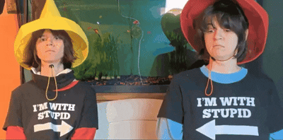 two people wearing hats and shirts that say i 'm with stupid