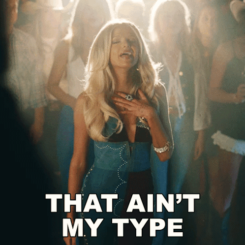 a woman singing in front of a crowd with the words that ain 't my type below her