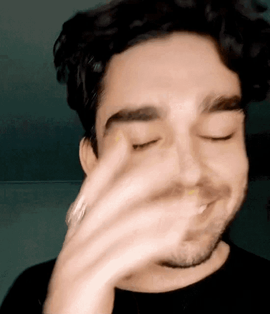 Man closes his eyes and covers his face in embarrassment.