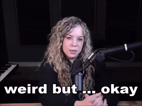 a woman sitting in front of a microphone with the words weird but okay written below her