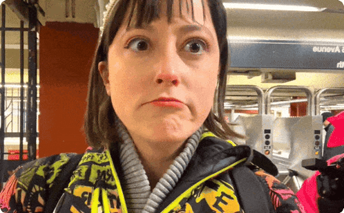 a woman making a funny face in front of a sign that says eunova