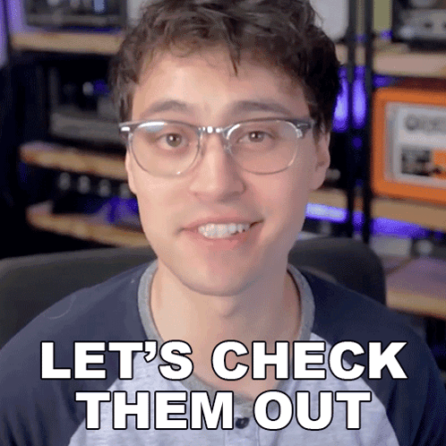 a man wearing glasses is smiling and says let 's check them out