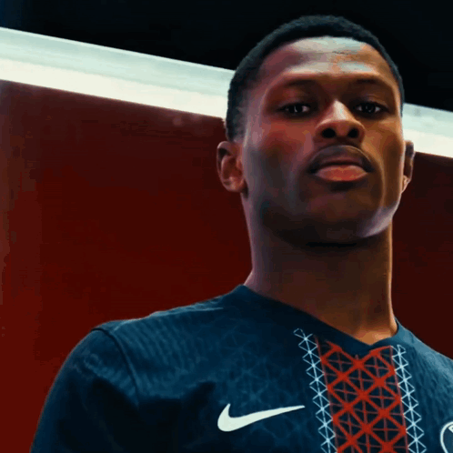 a man wearing a nike shirt that says paris