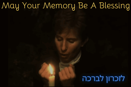a person holding a lit candle with the words may your memory be a blessing above them