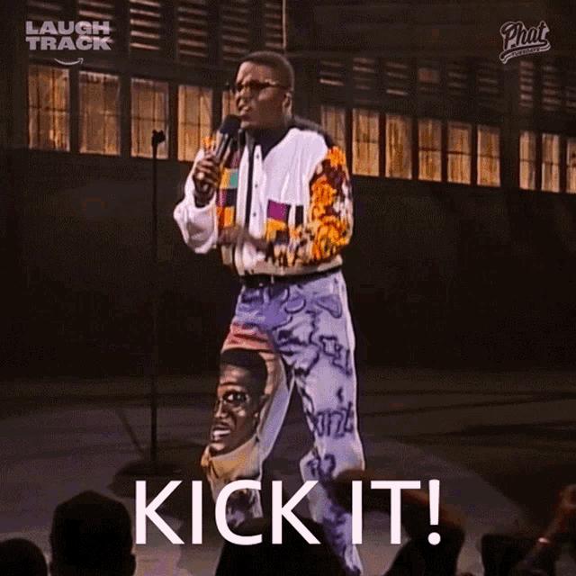 a man stands in front of a microphone with the words kick it on the screen