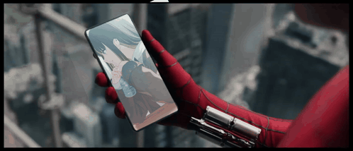 a person wearing a spiderman glove is holding a phone