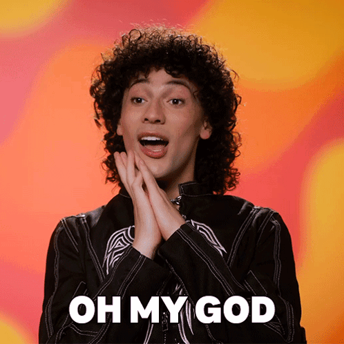a man with curly hair says " oh my god " with his hands on his face