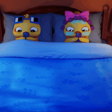 two cartoon characters are laying on a bed with a blue comforter