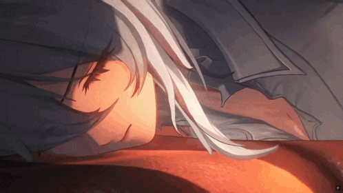 a girl with long white hair is sleeping on a bed .