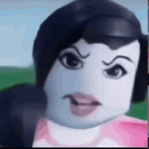 a close up of a doll 's face with a very angry expression .