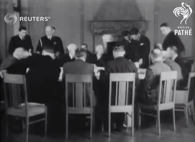 a group of men are sitting around a table with reuters written on the bottom right