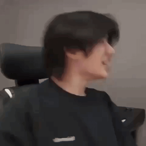a man is making a funny face with his mouth open while wearing a black shirt .