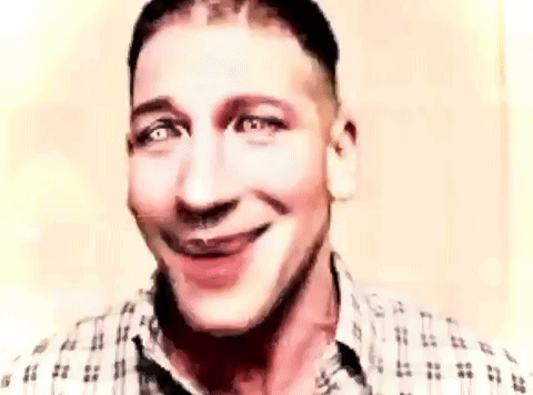 a man in a plaid shirt is smiling and making a face .