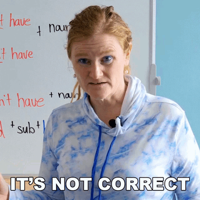 a woman standing in front of a white board with the words it 's not correct written on it