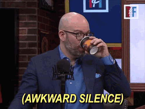 A man drinks from a mug as yellow text reads “(AWKWARD SILENCE).”