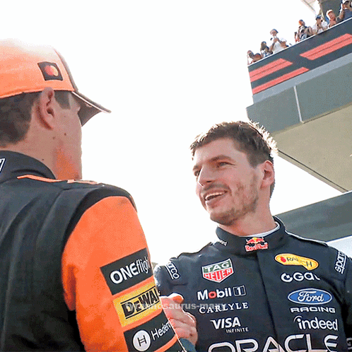 a man in a racing suit with the word oracle on his sleeve