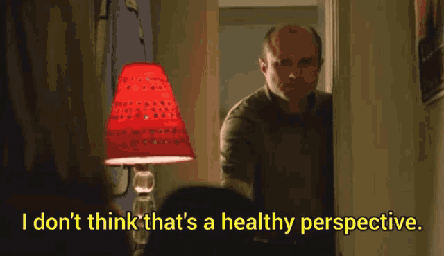 a man standing in front of a lamp with the words " i don t think that 's a healthy perspective " below him
