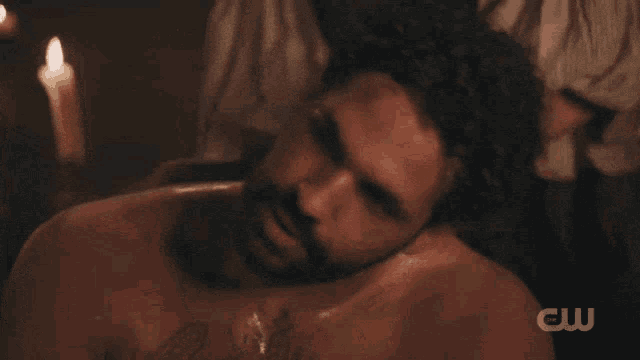 a man with a beard is getting a massage from someone with the letters cw on the bottom