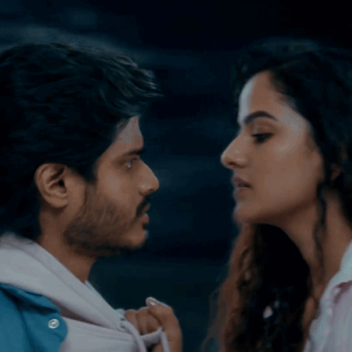A couple gazes at each other closely before a kiss.