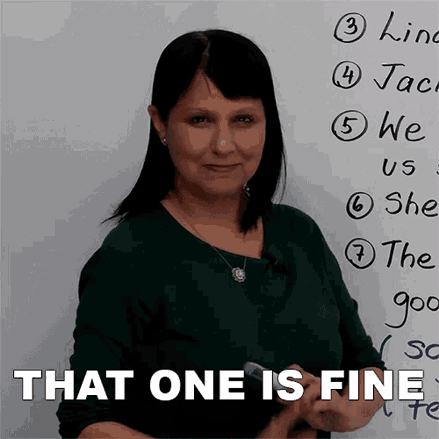 a woman standing in front of a white board with the words that one is fine written on it