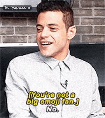 a man in a gray shirt is laughing and saying `` you 're not a big emoji fan . ''