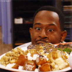 A man stares eagerly at a large plate of food.