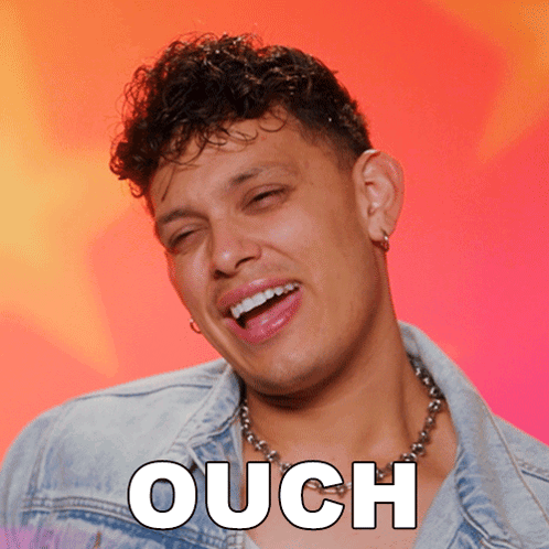 a man wearing a denim jacket and a necklace with the word ouch written on it