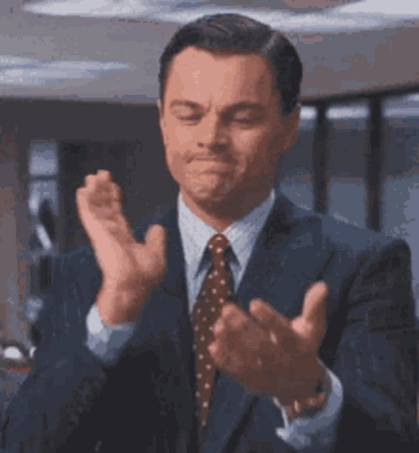 Leonardo DiCaprio claps in a suit with the caption “YAY!”