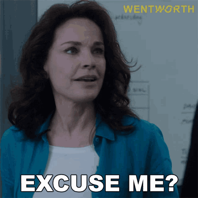 a woman says " excuse me " in front of a white board