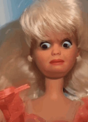A Barbie doll gives a wide-eyed uneasy side-eye.